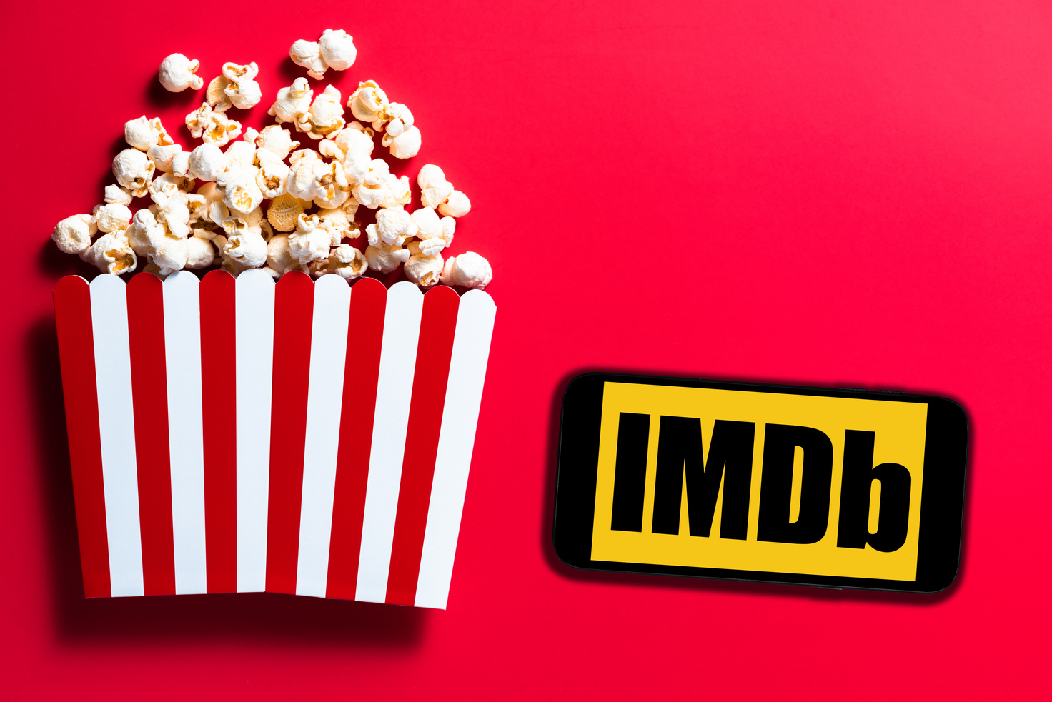 IMDb Logo and a Popcorn Bucket on a Red Background